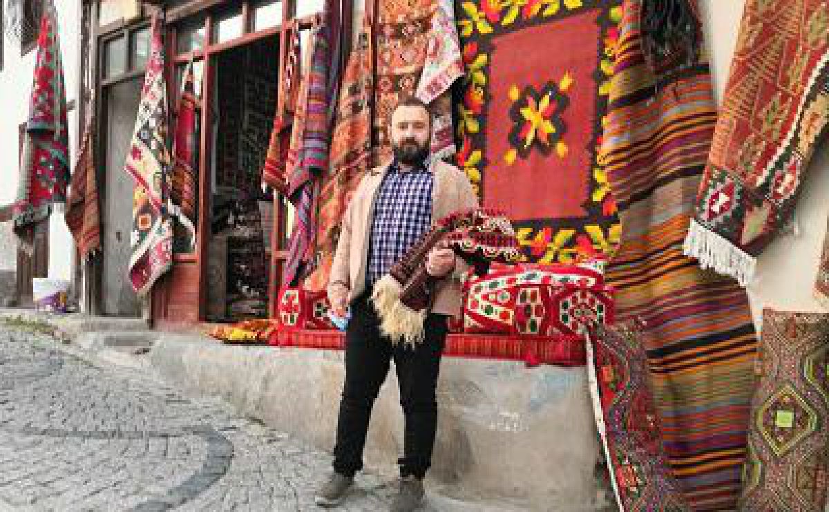 Gabriel from Brio Carpet Care in front of a Turkish rug shop